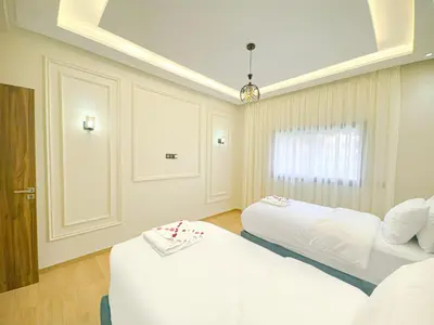 a bedroom with two beds and a window at Perle de Marrakech avec Piscine et Parking in Marrakech