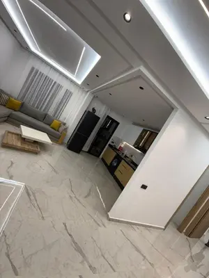 a living room with white walls and marble floors at L'aube de l'éveinage 2 bedrooms Marrakech station in Marrakech