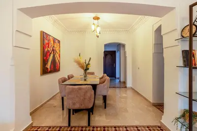 a dining room with a table and chairs at Urban Pearl terrace and pool in Marrakech