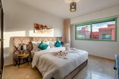 a bedroom with a large bed and a window at Urban Pearl terrace and pool in Marrakech