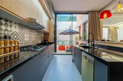 a kitchen with gray cabinets and a counter top at Villa Traverta Marrakech, 5 Suites, Heated Pool, Workation & Authentic Hammam in Marrakech