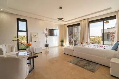 a bedroom with a large bed and a large window at Villa Traverta Marrakech, 5 Suites, Heated Pool, Workation & Authentic Hammam in Marrakech
