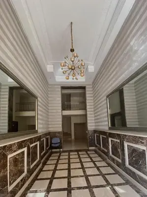 a room with a ceiling and a chandelier at Modern 2-Bedroom Apartment in Gueliz in Marrakech