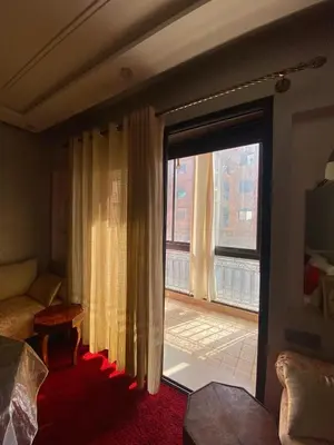 a living room with a large window and a couch at Modern 2-Bedroom Apartment in Gueliz in Marrakech