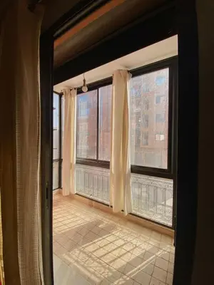 an empty room with two large windows with a view at Modern 2-Bedroom Apartment in Gueliz in Marrakech