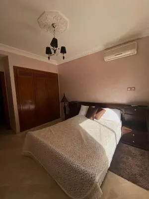 a bedroom with a white bed and a ceiling at Modern 2-Bedroom Apartment in Gueliz in Marrakech