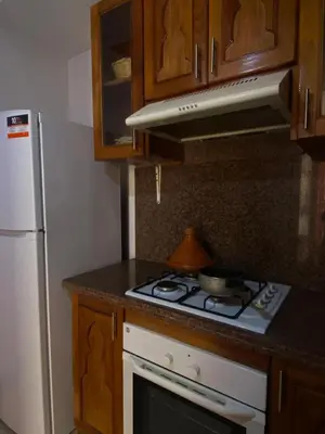 a kitchen with a stove and a white refrigerator at Modern 2-Bedroom Apartment in Gueliz in Marrakech