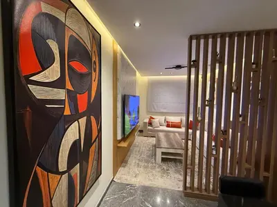 a living room with a large painting on the wall at Cosy Studio Cinema PS5 and home cinema 10 min Downtown in Marrakech