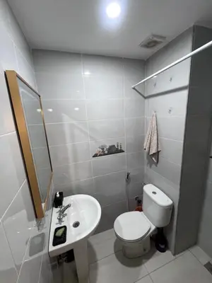 a bathroom with a white toilet and a sink at Darhome in Marrakech