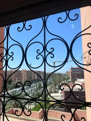 a window with a view of a city at Darhome in Marrakech