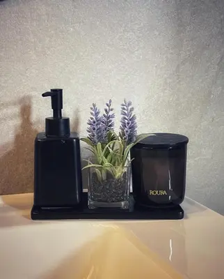 a black soap dispenser and a potted plant on a table at studio à marrakech in Marrakech