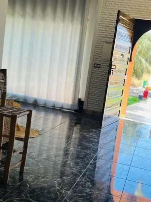 a room with a door and a table and a floor at Spacious and comfortable villa in Marrakech