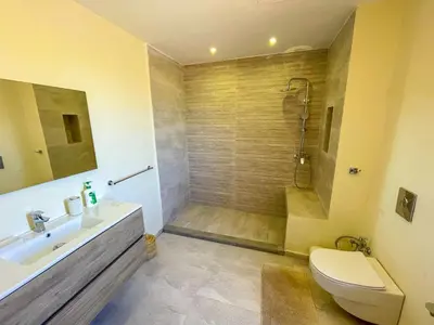 a bathroom with a shower and a toilet and a sink at Sublime Villa avec Piscine et Jardin à Marrakech in El Rhechat