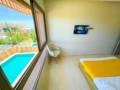 a bedroom with a bed and a swimming pool at Sublime Villa avec Piscine et Jardin à Marrakech in El Rhechat