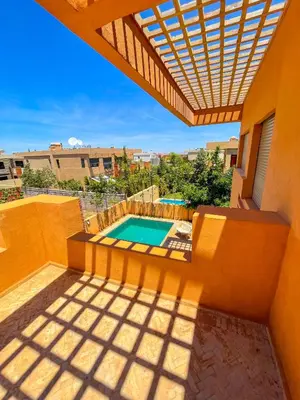 a view of a swimming pool from the balcony of a house at Sublime Villa avec Piscine et Jardin à Marrakech in El Rhechat