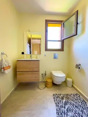 a bathroom with a sink and a toilet and a mirror at Sublime Villa avec Piscine et Jardin à Marrakech in El Rhechat