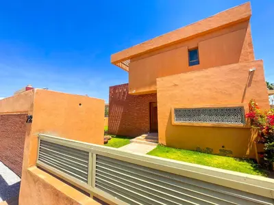 a house with a fence in front of it at Sublime Villa avec Piscine et Jardin à Marrakech in El Rhechat