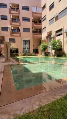 a swimming pool in front of a building at Refined stay with 4 pools in Marrakech in Marrakech
