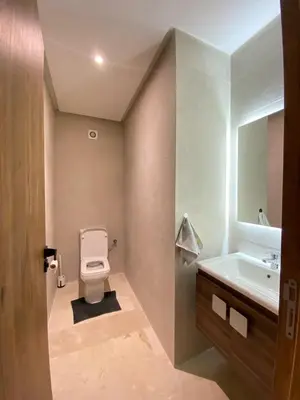 a bathroom with a toilet and a sink and a mirror at Refined stay with 4 pools in Marrakech in Marrakech