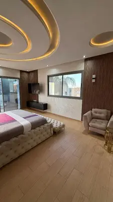 a large bedroom with a large bed and a couch at Villa Targa Marrakech in Marrakech
