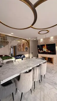 a dining room with a large marble table and chairs at Villa Targa Marrakech in Marrakech