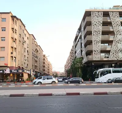 a city street with cars parked in front of buildings at Marrakech guliz location vacances in Marrakech