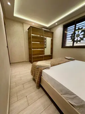 a bedroom with a large bed and a window at Yumo - Cozy 3 in Marrakech