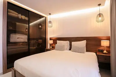 a bedroom with a large white bed and two lamps at Palmier d'or - Marrakech Centre in Marrakech
