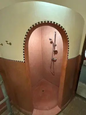 a shower in a bathroom with an archway at Luxury riad breakfast included in Marrakech