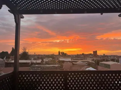 a view of a sunset from a balcony at Luxury riad breakfast included in Marrakech