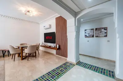 a dining room with a table and chairs at Cosy Palace elevator and pool in Marrakech