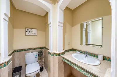 a bathroom with a toilet and a sink at Cosy Palace elevator and pool in Marrakech
