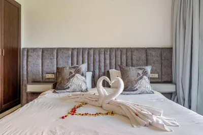two white swans making a heart on a bed at Cosy Palace elevator and pool in Marrakech