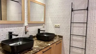 a bathroom with a black sink and a mirror at L'Écrin by Louhou Collection - Plein centre in Marrakech