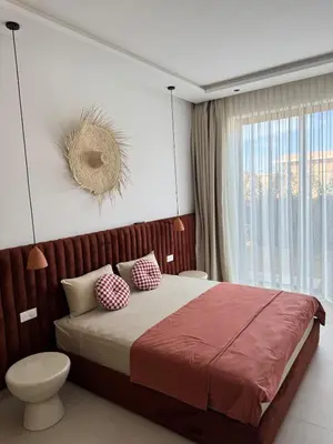 a bedroom with a large bed and a window at Villa Terracotta Marrakech in Segraga