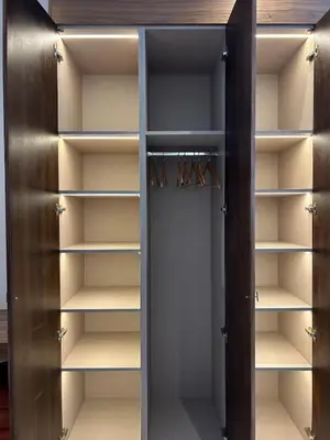 a walk in closet with wooden doors and shelves at Villa Terracotta Marrakech in Segraga