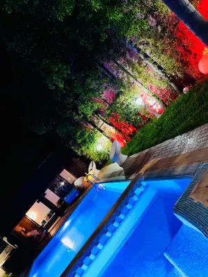 a view of a swimming pool at night at Villa Youri in Marrakech