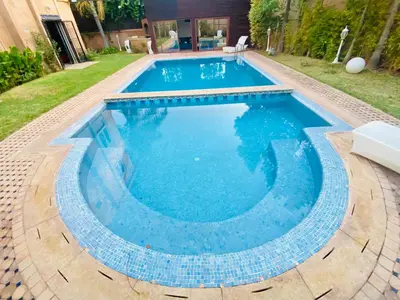 a large swimming pool with blue water in a yard at Villa Youri in Marrakech