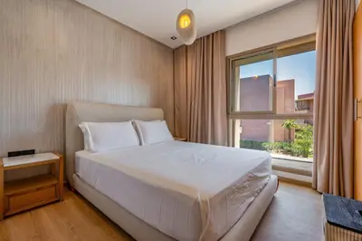 a bedroom with a white bed and a window at Marrakech, mon amour in Marrakech