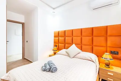 a bedroom with a bed with two pairs of shoes on it at Appart 3 CH Menara Garden in Marrakech