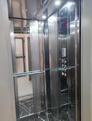 a glass door of a elevator in a room at Appartement à Marrakech confortable et équipe in Marrakech