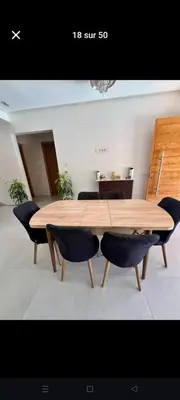 a wooden table with chairs around it in a room at Villa privée in Taazout