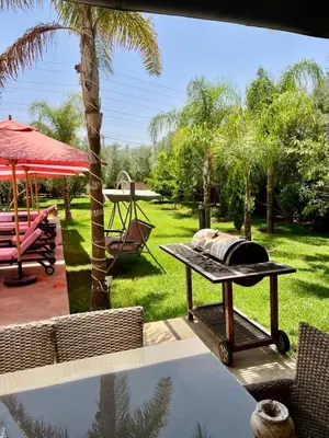 a picnic table with a grill on a patio at Villa privée in Taazout