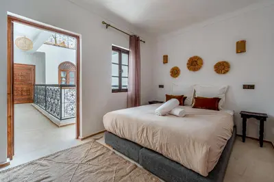 a bedroom with a large bed and a balcony at Riad Zahra Private Pool and Breakfast10min Jemaa in Marrakech