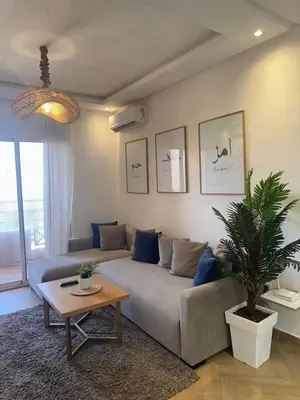 a living room with a couch and a table at Elegant apartment in Guéliz in Marrakech
