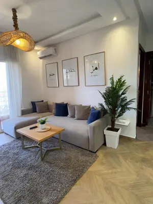 a living room with a couch and a table at Elegant apartment in Guéliz in Marrakech