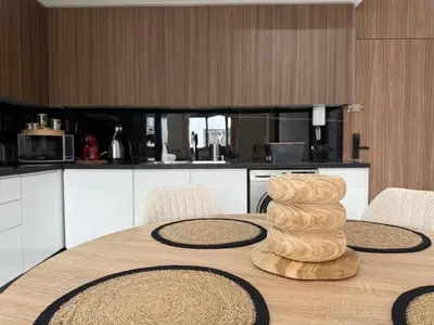 a kitchen with a table with a wooden tower on it at Beautiful modern apartment 1 bedroom 2 people Menara Garden 2 in Marrakech