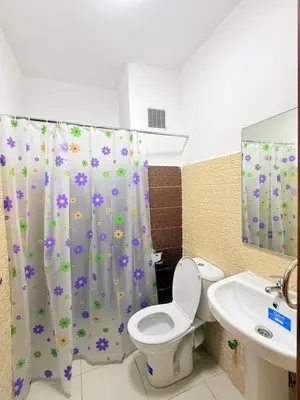 a bathroom with a toilet and a sink and a shower curtain at 2 Aprt Moderne Neuf Adapté Au Famille in Marrakech
