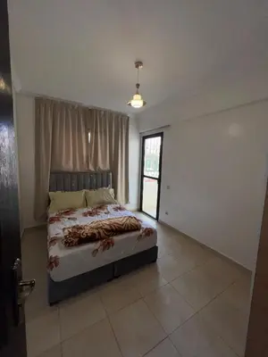 a bedroom with a bed in a room with a window at aboube gulize marrakeche in Marrakech