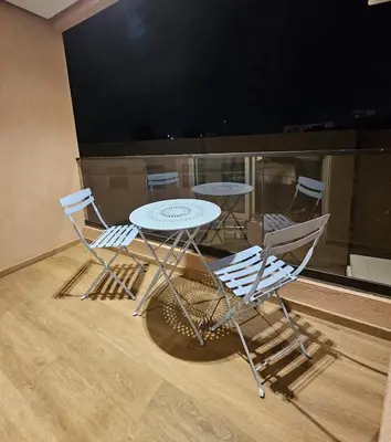 a table and two chairs and a table with a tv at Luxurious New Designer Apartment in Marrakech in Marrakech